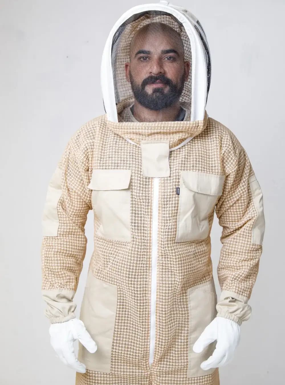 Beekeeper in a three-layer ventilated beekeeping coverall with an attached fencing veil, for bee removal work