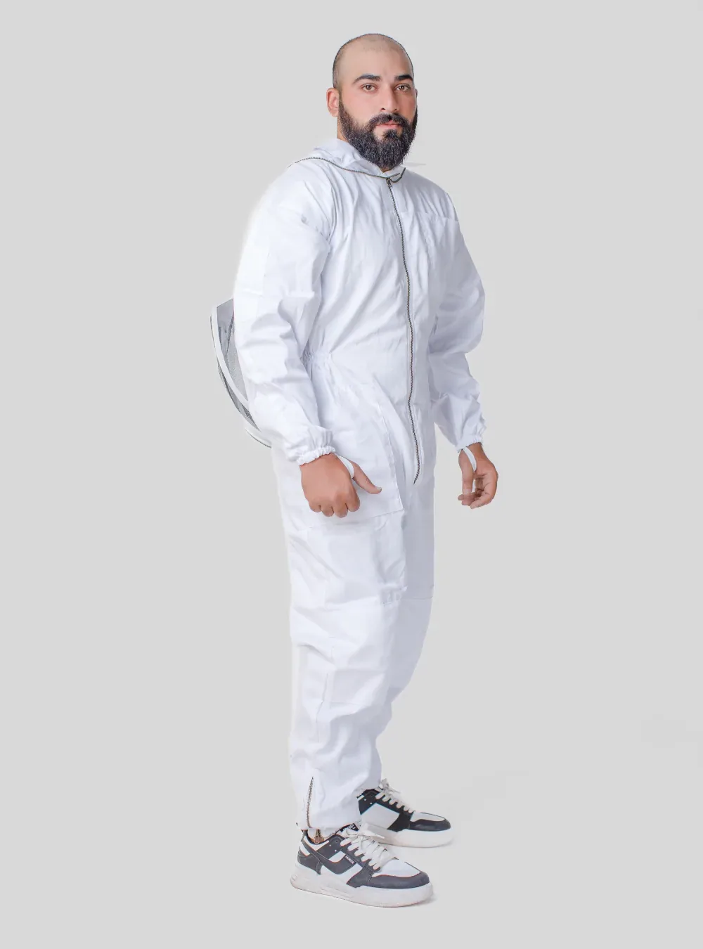 Side view of a beekeeper in a white cotton fencing-veil suit, showing body length and leg length to the shoes