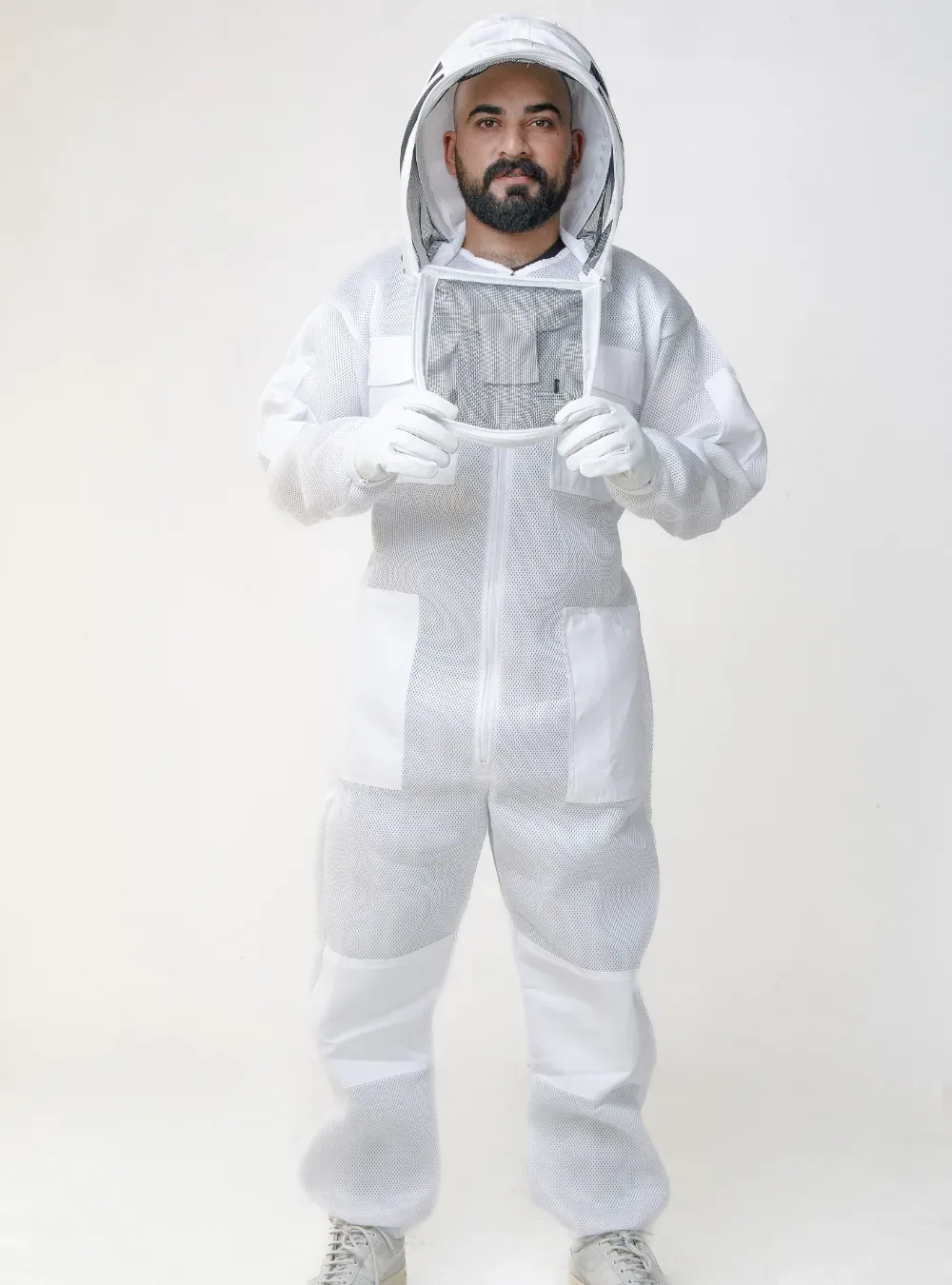 Beekeeper in a white ventilated mesh suit holding both arms forward, with room across the back and in the sleeves