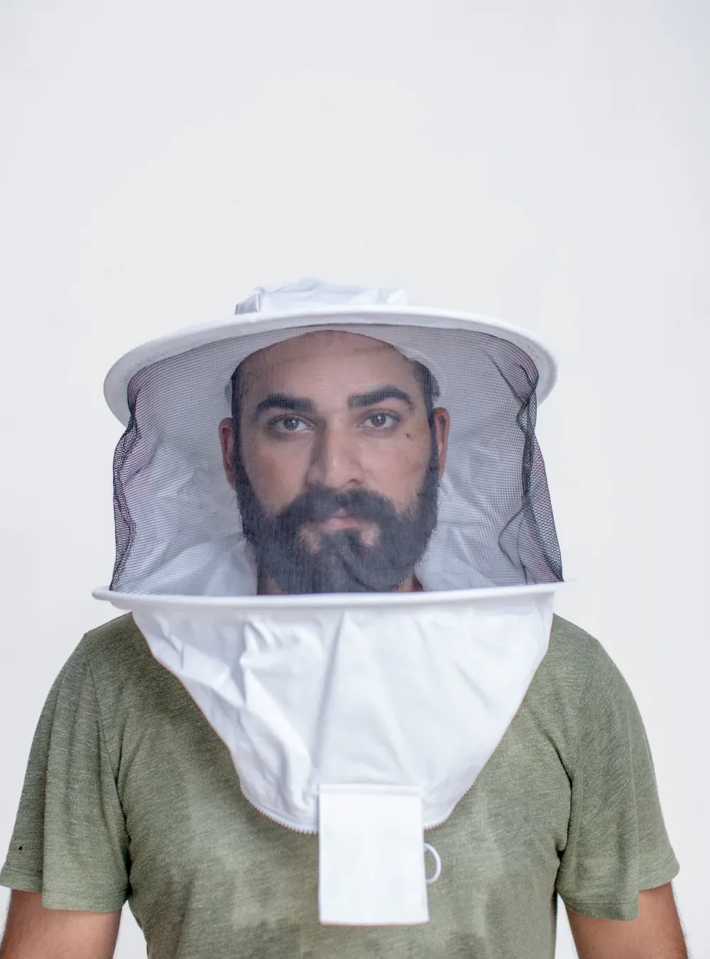 Beekeeper in a round veil seen from the front, with the adjustable headband holding the hat level